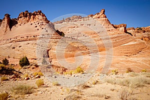 Rocks and Mountains along a trail to Tunnel Slot during sunny day with blue sky in Escalante National Monument, Grand Staircase