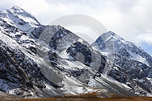 Rocks, peaks, glaciers and snowfields in the mountain landscape photo