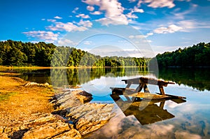 Rocks and a picnic table in Lake Marburg, at Codorus State Park, Pennsylvania.