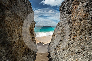 Rocks on the Puka beach, Beautiful azure sea and bright blue sky.