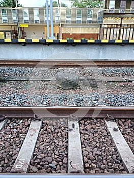 rocks between the rails of a 2-track train