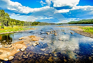 Rocks in the river surrounded by trees in Sweden