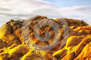 Rocks rounded against sky yellow cracks