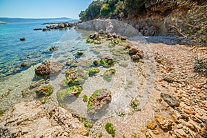 Rocks and sand in Lazzaretto shore in springtime photo