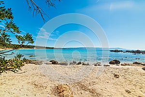 Rocks and sand in Le Bombarde beach in Alghero