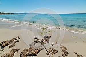 Rocks and sand in Le Bombarde beach in Alghero