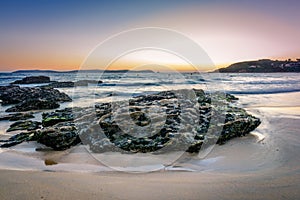 Rocks on the sand in the Rias Baixas, Galicia photo