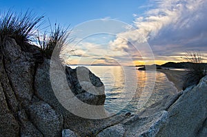 Rocks, sand, sea and a beach with a small cave at sunset, Sithonia