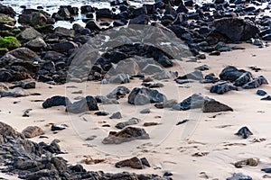 Rocks in the sands of Ondina beach on a sunny day photo