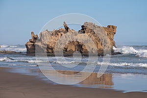 Rocks on the sandy beach at Brenton on Sea, Knysna, photographed at sundown, South Africa.