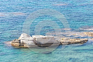 Rocks in the sea off the coast of Cyprus photo