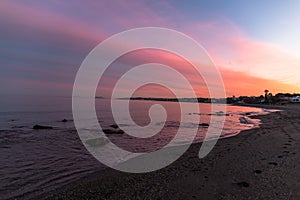 Rocks in the sea with a pink sunset