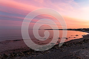 Rocks in the sea with a pink sunset