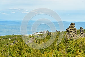 Rocks and Shad Tchup Ling Buddhist monastery on mountain Kachkanar. The Urals. Russia