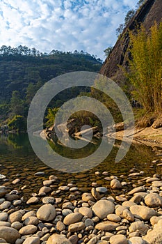 Rocks on the shore and strange shaped mountains of Wuyishan, China