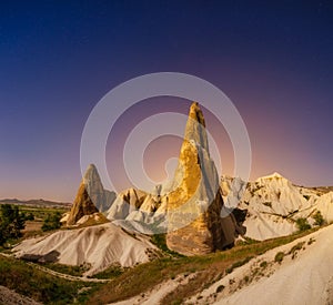 Rocks and the sky with stars. Cappadocia, Turkey. View of the rocks at night. Landscape in the summertime.