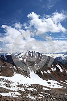 Rocks, snow, clouds and sky in Caucasus mountains
