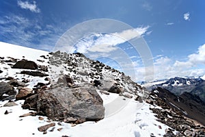 Rocks, snow, sky and clouds in mountains