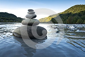 Rocks stack on the coast of Mountain River, concept of balance and harmony photo