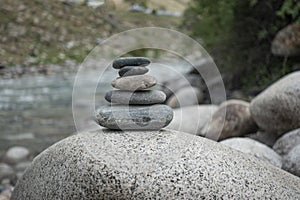 Rocks stack on the coast of summer Mountain River, concept of balance and harmony