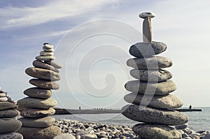 Rocks stacked on the beach. Pyramid.