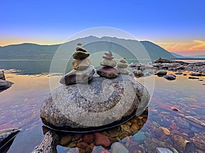 Rocks stacked on a large boulder at Glacier National Park, MT