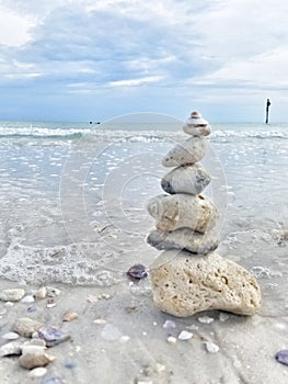 Rocks stacked near the water on the beach