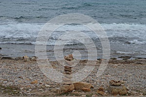 Rocks or stone balancing tower with Rocky Beach and sea background