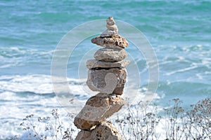 Rocks or stone balancing tower with sea background