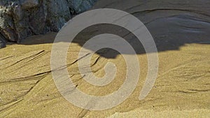 Rocks and stones on coastline of sandy Adraga beach, Portugal coast