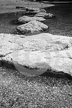 Rocks stones isolated in water in black and white, slovenia
