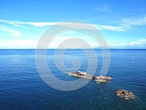 rocks on summer sea and blue sky background