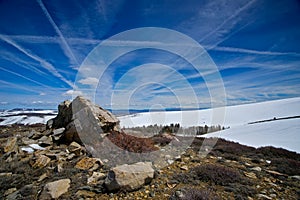 Rocks Under a Contrail Sky