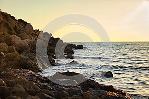Rocks and water at Golden Bay at sunset