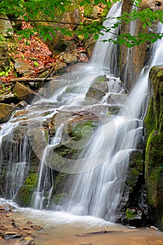 Rocks in waterfall stream. beautiful nature scenery in forest. cascade of rapid mountain river