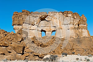 Rockwall with two windows formed by wind erosion - Sahara photo