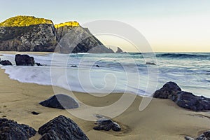 Rocky Atlantic ocean coastline of Adraga beach, Portugal