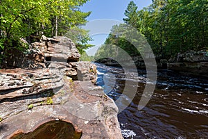 Rocky banks and forests along kettle river at banning