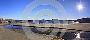 Rocky Bay beach, river and islands of Saint Lawrence Estuary in Riviere-au-Tonnerre area, Cote-Nord, Quebec photo