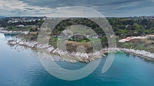 Rocky beach around Savudrija or Alberi area viewed from above. Drone view of visible rocks leading into the blue sea on a cloudy photo