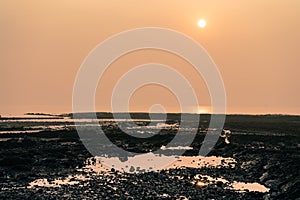 Rocky beach at bandstand in mumbai from the rocky beach near joggers pack at sunset.