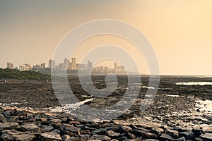 Rocky beach at bandstand in mumbai from the rocky beach near joggers pack at sunset.