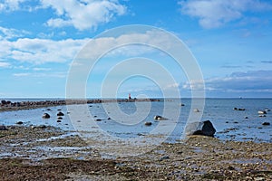 Rocky beach and braid with a small lighthouse