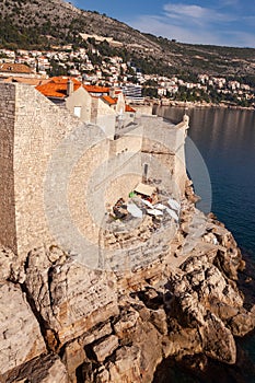 Rocky beach at the city wall of Dubrovnik in Croatia