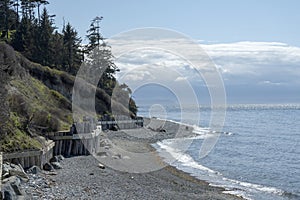Rocky beach with constructed retaining wall along Puget Sound