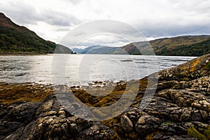 The rocky beach at Elgol on the Isle of Skye in Scotland. minimalist Scottish landscape of a misty morning on a calm, Loch Fada la