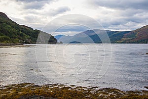 The rocky beach at Elgol on the Isle of Skye in Scotland. minimalist Scottish landscape of a misty morning on a calm, Loch Fada la photo