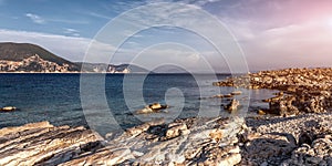 Rocky beach landscape at dusk. Wonderful Seascape during sunset. Coastal landscape of rocky beach calm sea and blue sky