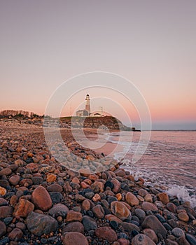 Rocky beach and lighthouse at Montauk Point State Park, in the Hamptons, Long Island, New York