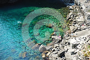 Rocky beach in Manarola, one of the five centuries-old villages of Cinque Terre, Liguria, Italy